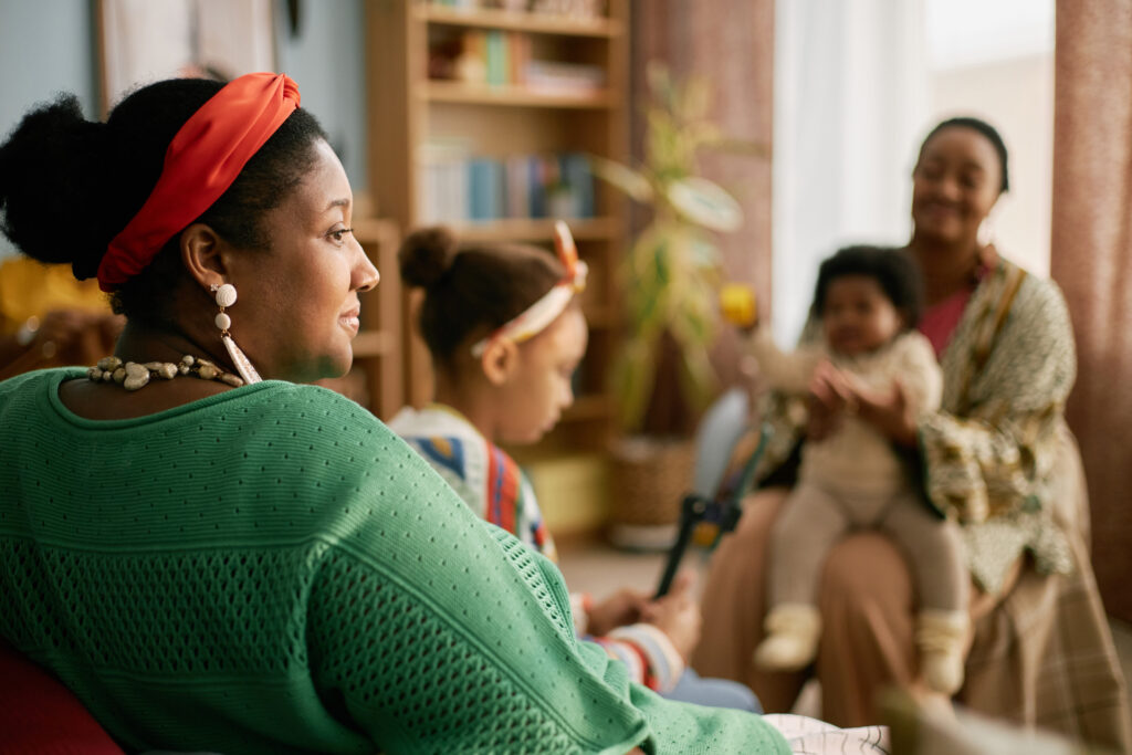 Black Woman Relaxing with Family in Cozy Living Room
